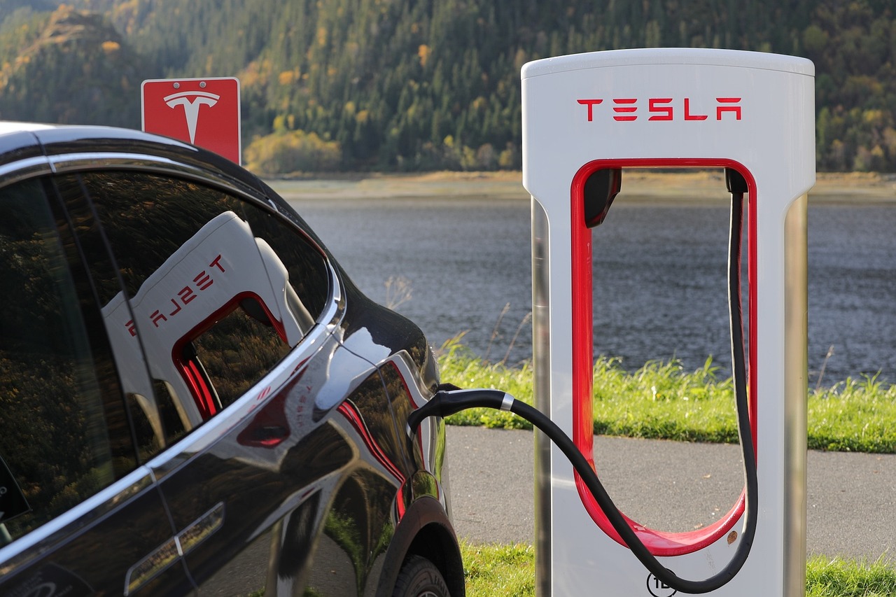 Tesla charging at a station