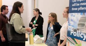 Professors Caitlin Grady and Erica Gralla discussing with attendees.
